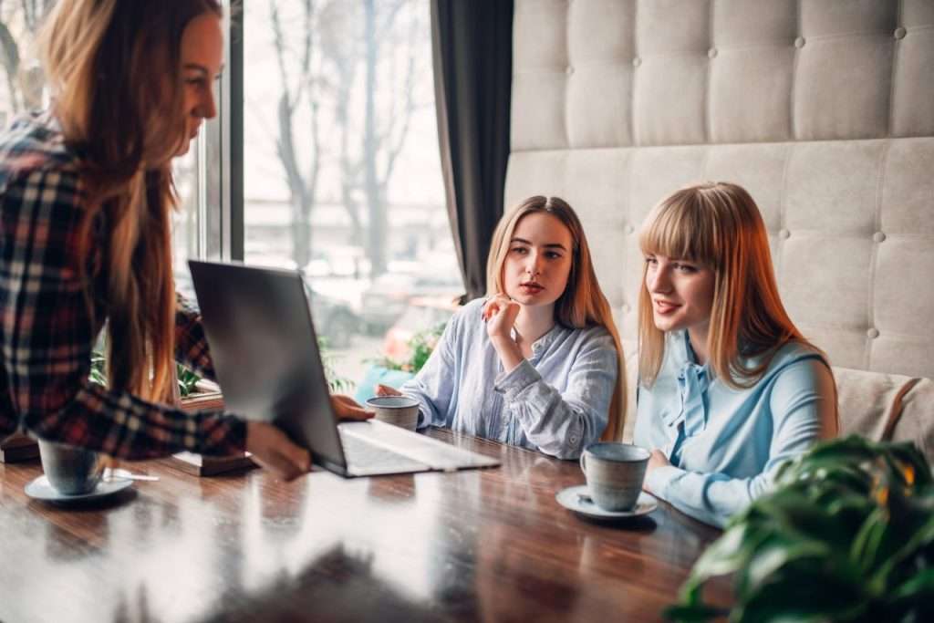 Business owner reviewing website design and lead generation results on a laptop